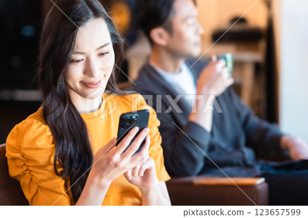 Young woman checking her smartphone in a cafe 123657599