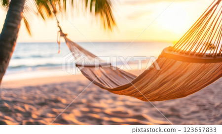 Hammock swaying between palm trees on a sandy beach at sunset, with golden sunlight casting a warm glow over the ocean waves and creating a peaceful tropical atmosphere. Hammock swaying between palm trees on a sandy beach at sunset, with golden sunlight casting a warm glow over the ocean waves and creating a peaceful tropical atmosphere. 123657833
