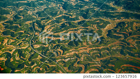 View From Airplane Window On Surroundings Of Chengdu, China. Mountainous Wooded Terrain Landscape Of China. Porthole View Or Called Bull's-eye Window. Discover China View From Airplane Window On Surroundings Of Chengdu, China. Mountainous Wooded Terrain Landscape Of China. Porthole View Or Called Bull's-eye Window. Discover China 123657916