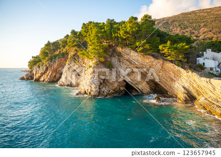 Coast landscape with rocks, sea and vegetation near ancient fort in Petrovac, Montenegro in winter time. Coast landscape with rocks, sea and vegetation near ancient fort in Petrovac, Montenegro in winter time. 123657945