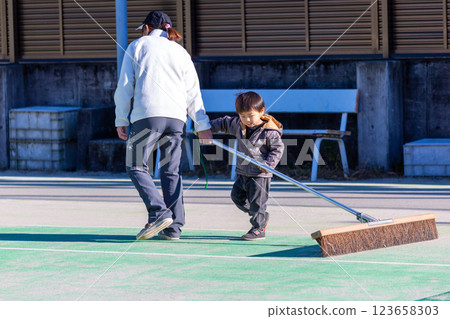 Parents and children brushing the tennis court 123658303