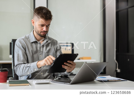Happy man, entrepreneur, small business owner working online. 123658686