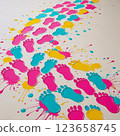 Colorful footprints with paint splashes on a light background.  123658745
