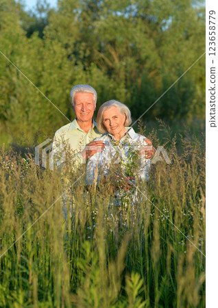 Loving mature couple in the park in summer Loving mature couple in the park in summer 123658779