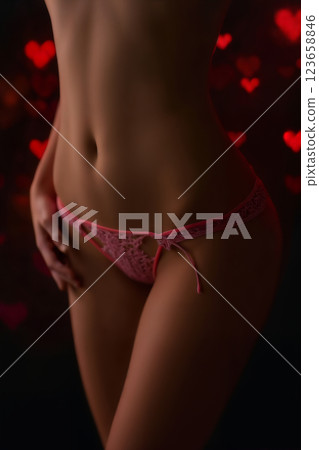 beautiful lingerie on a female body on a dark background with a bokeh heart 123658846