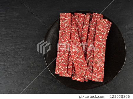 Beetroot crackers, thin rusk beet root bread, red diet multigrain crispbread, various seeds 123658866