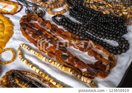 Amber stones market, polished orange gemstones closeup, natural Baltic amber gems jewelry store Amber stones market, polished orange gemstones closeup, natural Baltic amber gems jewelry store 123658919