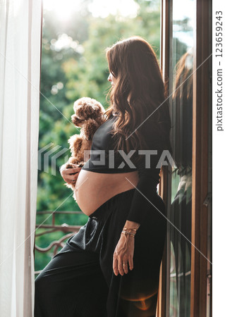 Beautiful pregnant woman at home in the doorway 123659243