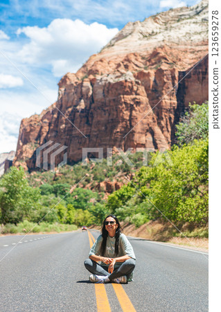 Happy girl on the road in Zion national park. Amazing view of the valley. 123659278
