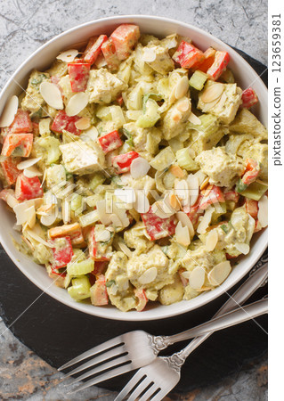 Pesto Chicken Salad with celery, onion, pepper and almond flakes closeup. Vertical top view 123659381