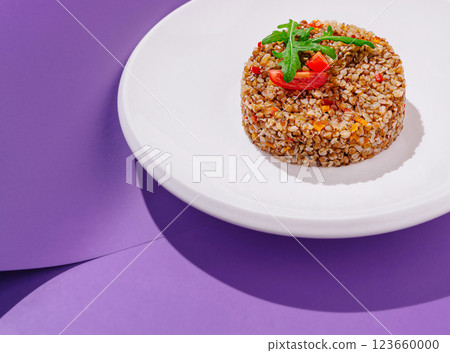 Delicious buckwheat salad served on a white plate with garnish Delicious buckwheat salad served on a white plate with garnish 123660000