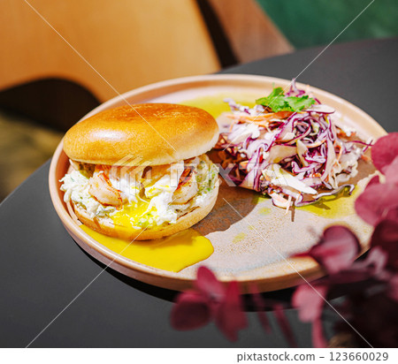Delicious shrimp burger with fresh slaw served on a plate 123660029