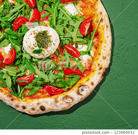 Freshly made pizza topped with arugula and cherry tomatoes 123660032