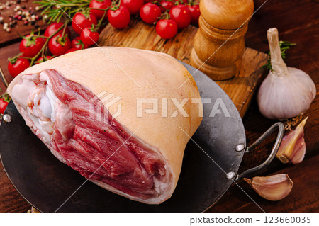 Fresh meat preparation at a rustic kitchen table with herbs 123660035
