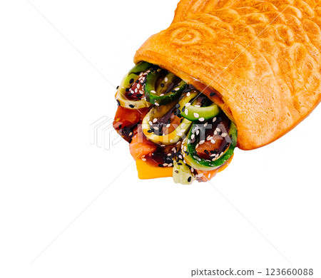 Crispy fish-shaped pastry filled with colorful vegetables and sauce Crispy fish-shaped pastry filled with colorful vegetables and sauce 123660088