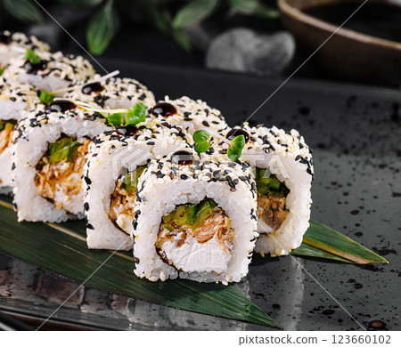 Elegant sushi roll platter on dark stone background Elegant sushi roll platter on dark stone background 123660102