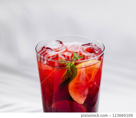 Refreshing red cocktail with lemon and mint on white background 123660109