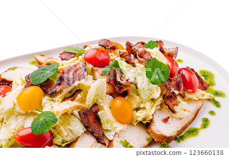 Fresh salad topped with crispy bacon and juicy tomatoes served 123660138