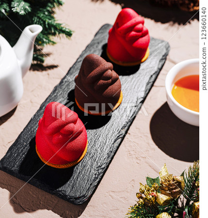 Festive dessert arrangement with tea and holiday decorations 123660140