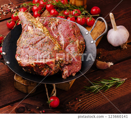 Freshly prepared meat with herbs and vegetables on wooden table 123660141