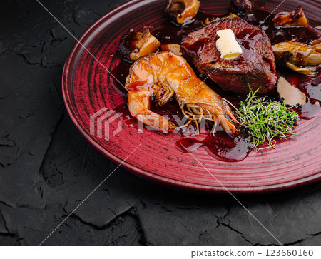 Gourmet dish featuring beef and shrimp with rich sauce Gourmet dish featuring beef and shrimp with rich sauce 123660160
