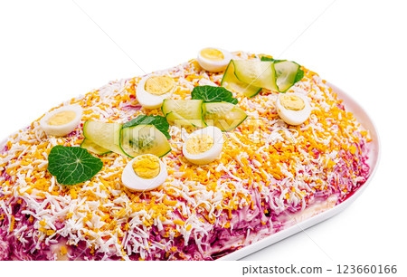 Colorful layered salad with eggs and vegetables on a white platter Colorful layered salad with eggs and vegetables on a white platter 123660166