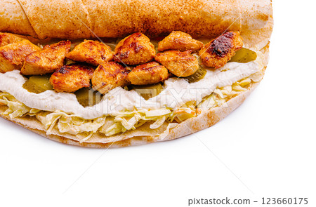 Grilled chicken wrap with creamy sauce and pickles on flatbread Grilled chicken wrap with creamy sauce and pickles on flatbread 123660175
