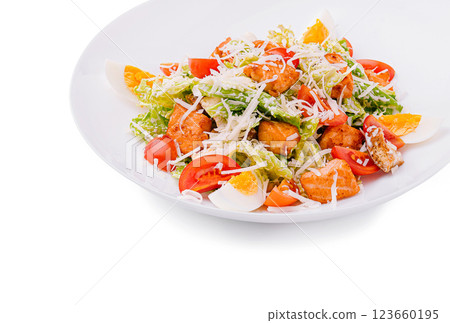 Fresh salad with shrimp, vegetables, and herbs on a white plate 123660195