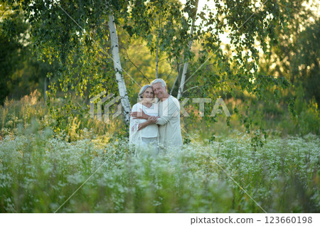 Loving mature couple in the park in summer Loving mature couple in the park in summer 123660198