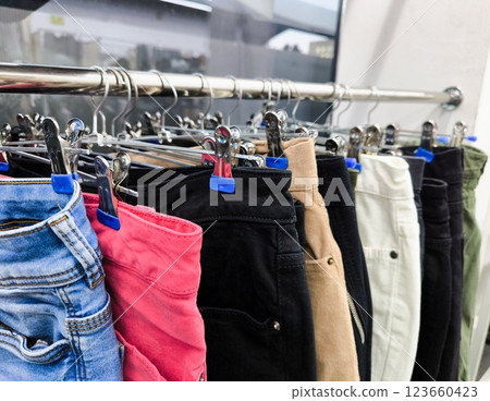 close up of jeans on a rack. close-up of a hanger with jeans close up of jeans on a rack. close-up of a hanger with jeans 123660423