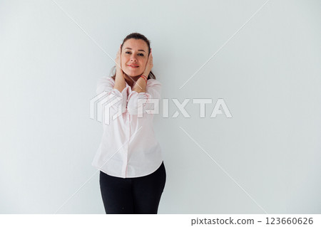 Portrait of a beautiful woman of 40 years old in a business suit near a white wall 123660626
