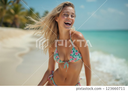 portrait of young beautiful girl wearing bikini swimsuit and posing on resort beach with view of sea and bright sky 123660711