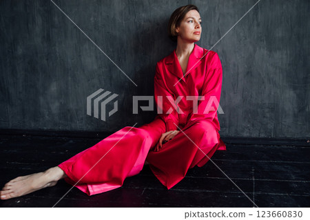 Beautiful woman 40 years old in pink silk pajamas 123660830