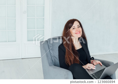 woman brunette sitting on chair online laptop woman brunette sitting on chair online laptop 123660894