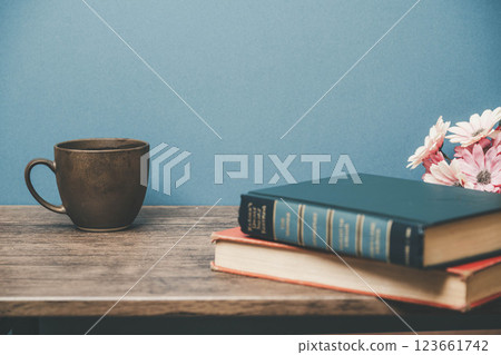 A mug and a book on a wooden desk A mug and a book on a wooden desk 123661742