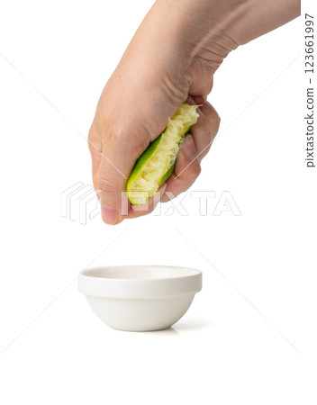 Squeezed lime isolated, squeezed out half green lemon on white background, burnout symbol 123661997