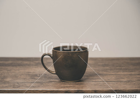 A mug on a wooden desk A mug on a wooden desk 123662022