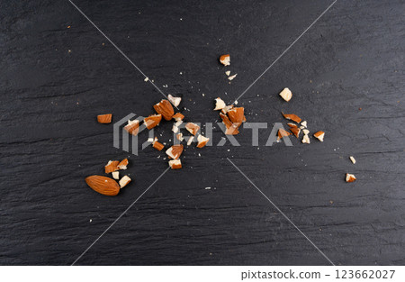 Crushed almonds, nut pieces, sliced scattered almond seeds and cut kernels collection on black background 123662027