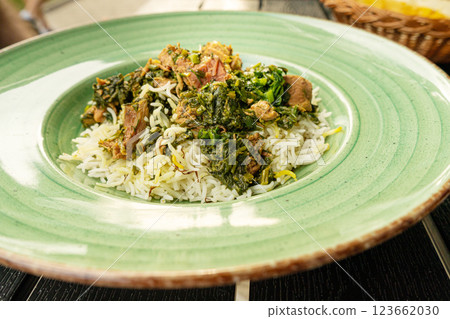 Pilau on Green Plate, Beef Pilaf, Traditional Asian Dish Plov also known as Polow, Pilav, Pallao, Pulao, Palaw 123662030