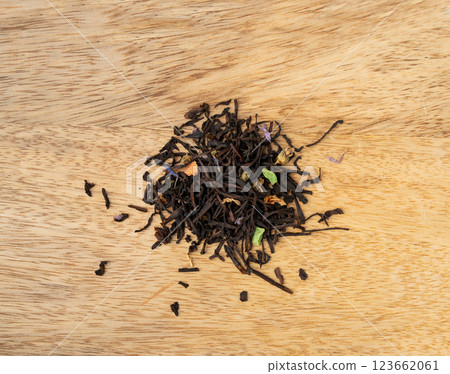 Flavored Black Tea Leaves Pile Texture, High Quality Black Tea Pile with Fruits and Flowers, Dry Tea Leaves Flavored Black Tea Leaves Pile Texture, High Quality Black Tea Pile with Fruits and Flowers, Dry Tea Leaves 123662061