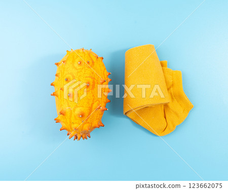 Kiwano on blue, jelly melon, cucumis metuliferus ripe fruit, orange horned melon, african horned cucumber 123662075