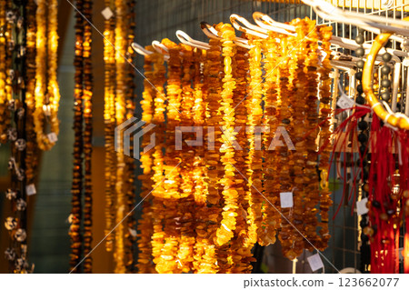 Amber stones market, polished orange gemstones closeup, natural Baltic amber gems jewelry store 123662077