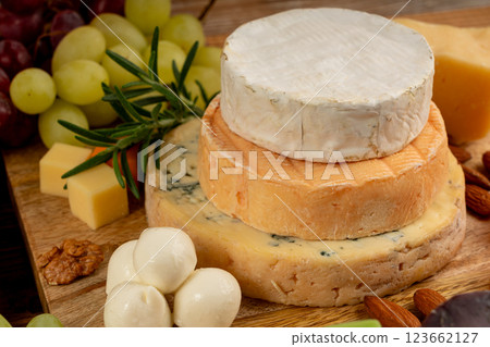 Cheese plate of color cheeses variety, yellow, white and blue cheese board, assorted dairy products Cheese plate of color cheeses variety, yellow, white and blue cheese board, assorted dairy products 123662127