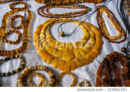 Amber stones market, polished orange gemstones closeup, natural Baltic amber gems jewelry store 123662161