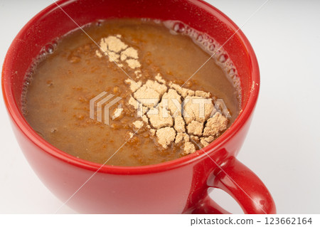 Maca powder drink isolated, dry Peruvian ginseng beverage, powder in water, ground ayak willku tea 123662164