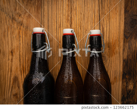 Old beer bottle, brown glass vintage beerbottle, a quality traditional time-tested drink symbol Old beer bottle, brown glass vintage beerbottle, a quality traditional time-tested drink symbol 123662175