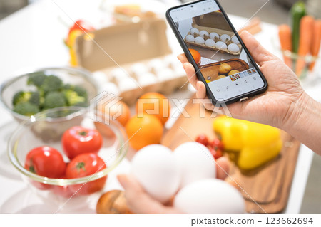 The hands of a middle-aged woman taking pictures of cooking ingredients with her smartphone The hands of a middle-aged woman taking pictures of cooking ingredients with her smartphone 123662694