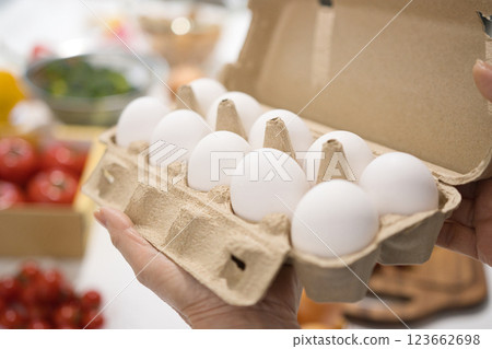 Middle-aged woman's hand holding fresh eggs 123662698