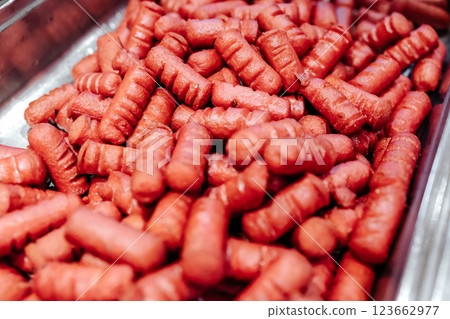 Fried small sausages. Cooking dinner. Harmful and high-calorie food. Fried small sausages. Cooking dinner. Harmful and high-calorie food. 123662977