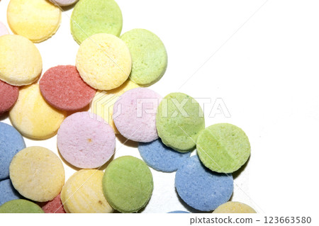 Close up of sugar paper confetti circle spots and colour dots on white background Close up of sugar paper confetti circle spots and colour dots on white background 123663580
